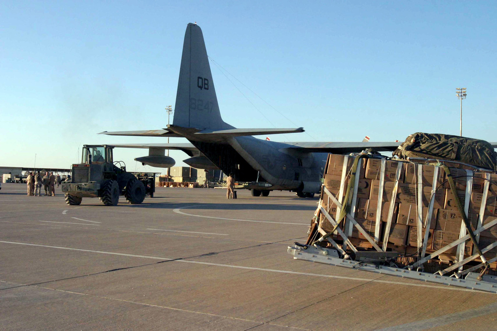 Palletized equipment and cargo is loaded onto a US Marine Corps (USMC ...