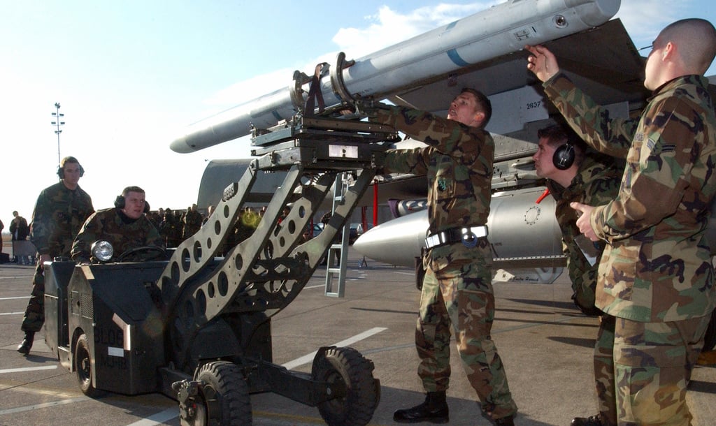 A U.S. Air Force 510th Fighter Squadron weapons load crew, load an AIM ...