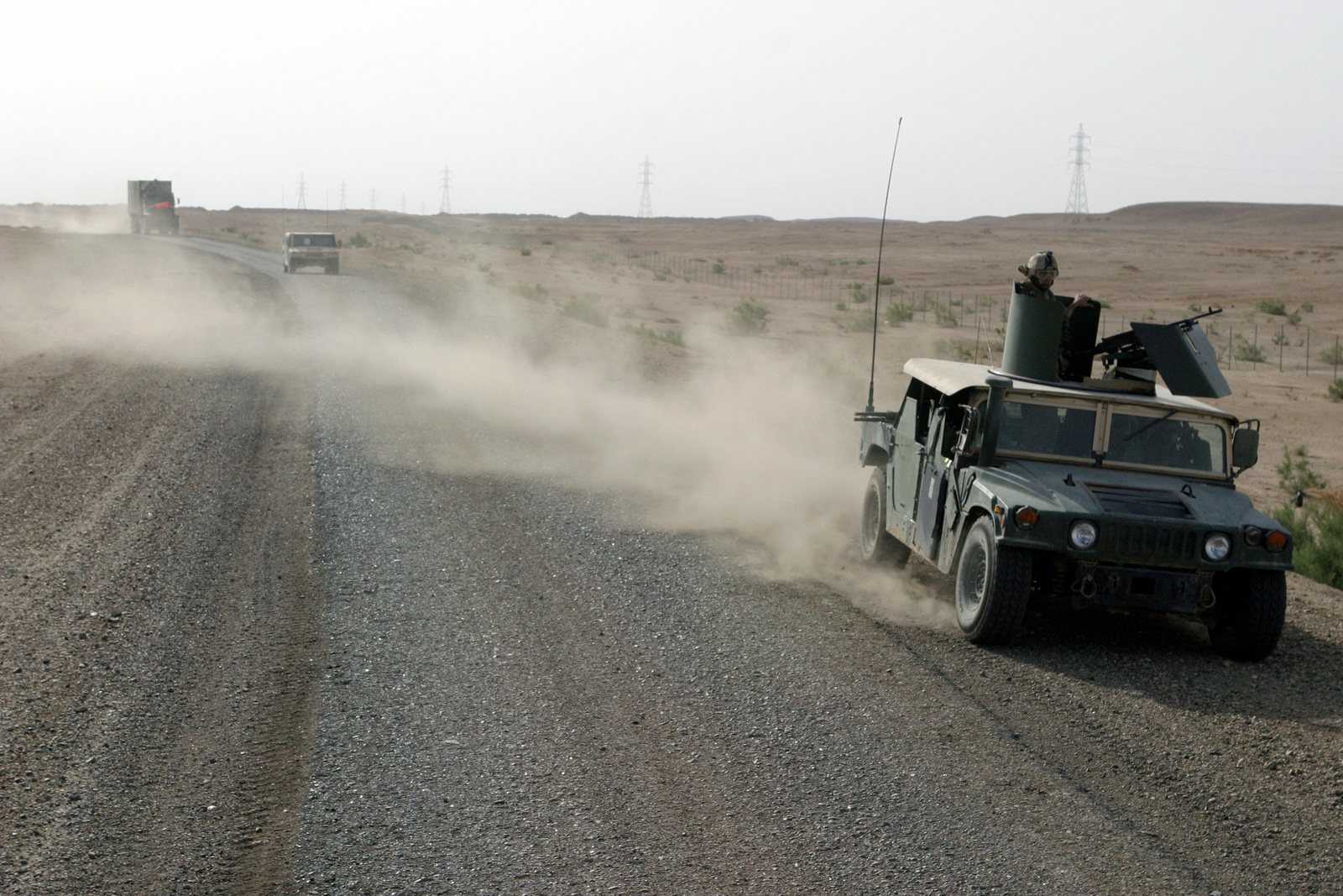 A convoy of US Marine Corps (USMC) vehicles from Combat Logistics ...