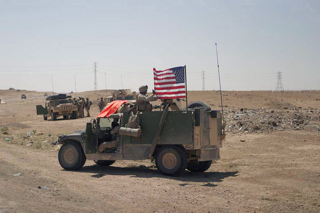 At a stop along the way to Al Ubaydi, a US Marine Corps (USMC) flank ...