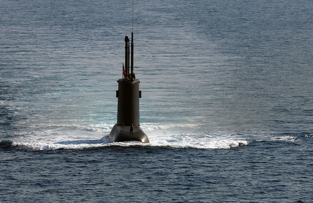 Capt. David Schappert, left, commander of Submarine Squadron 15, observes  the Japan Maritime Self-Defense Force submarine JS Soryu (SS-501) as it  arrives in Apra Harbor, Guam, for a port visit. - PICRYL 