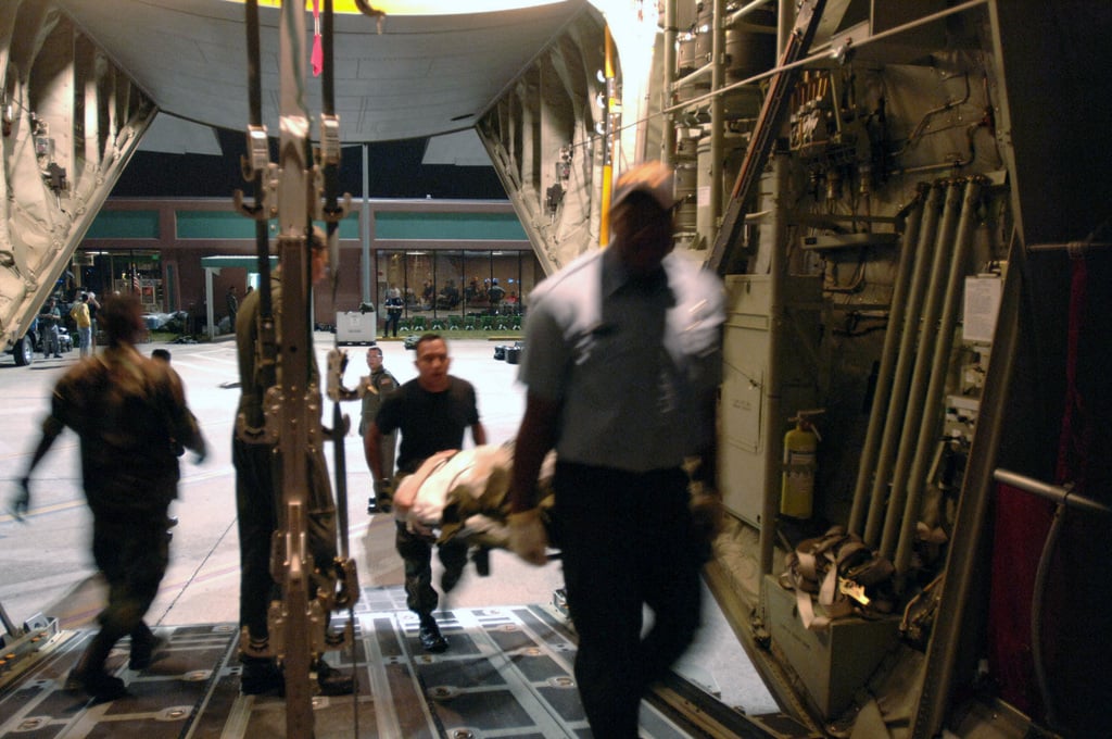 A Patient Is Carried Aboard A Us Air Force Usaf C 141 Starlifter