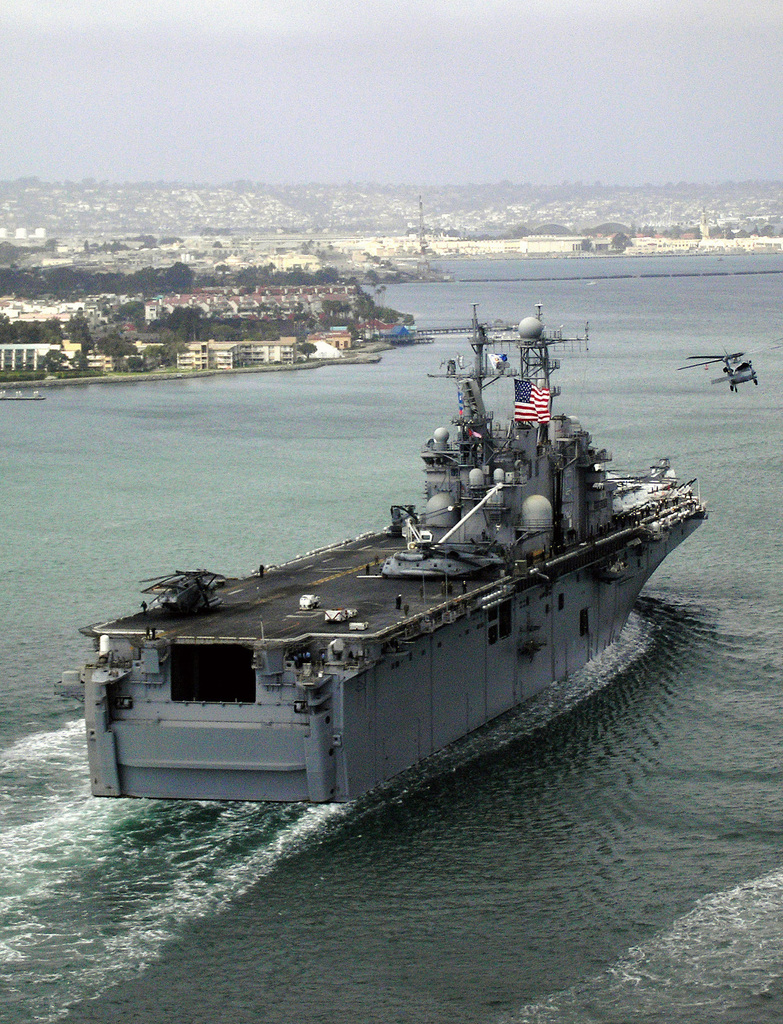 A US Navy (USN) HH-60H Seahawk helicopter assigned to Naval Air Station  (NAS) North Island, San Diego, California (CA), provides an escort for  security for the USN Amphibious Assault Ship the Tarawa