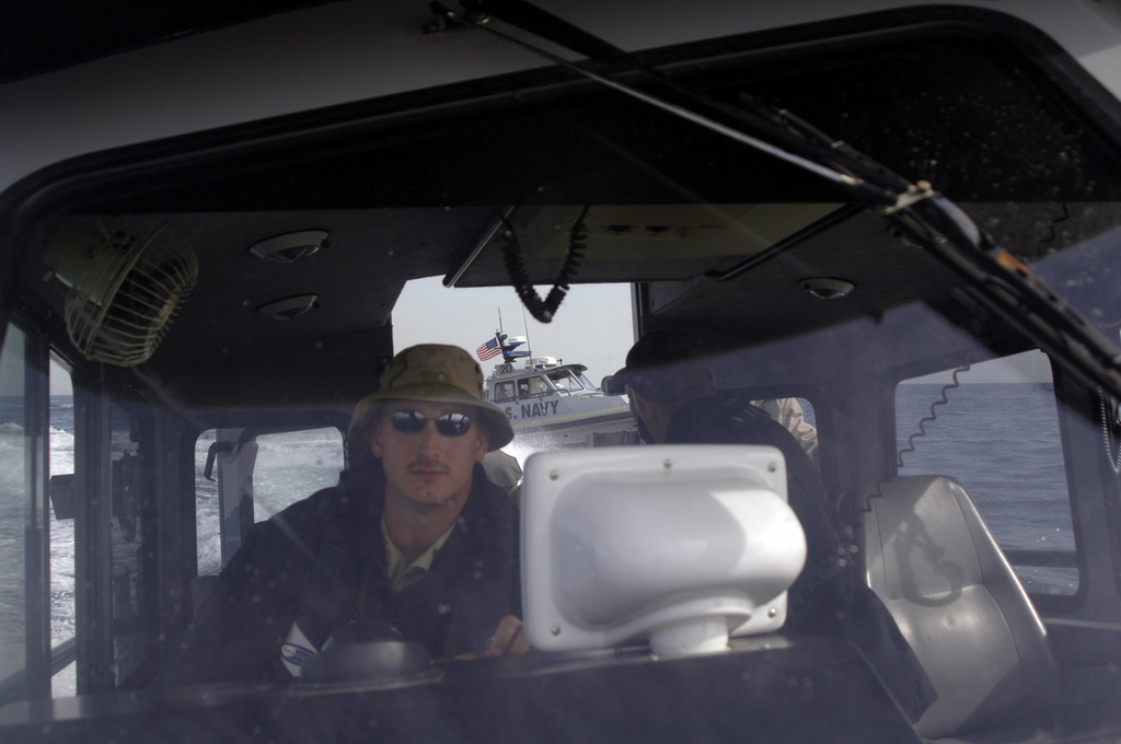 US Navy Engineman 2nd Class Anthony Bartelli (right) holds an