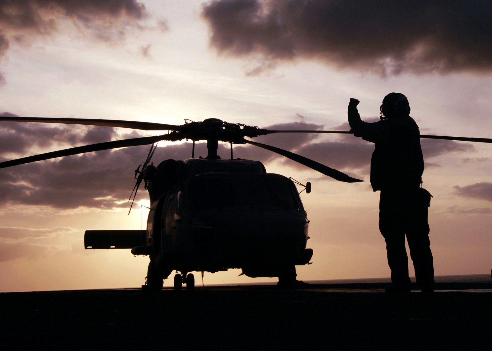 At dusk US Navy (USN) MH-60 Seahawk helicopter assigned to Helicopter ...