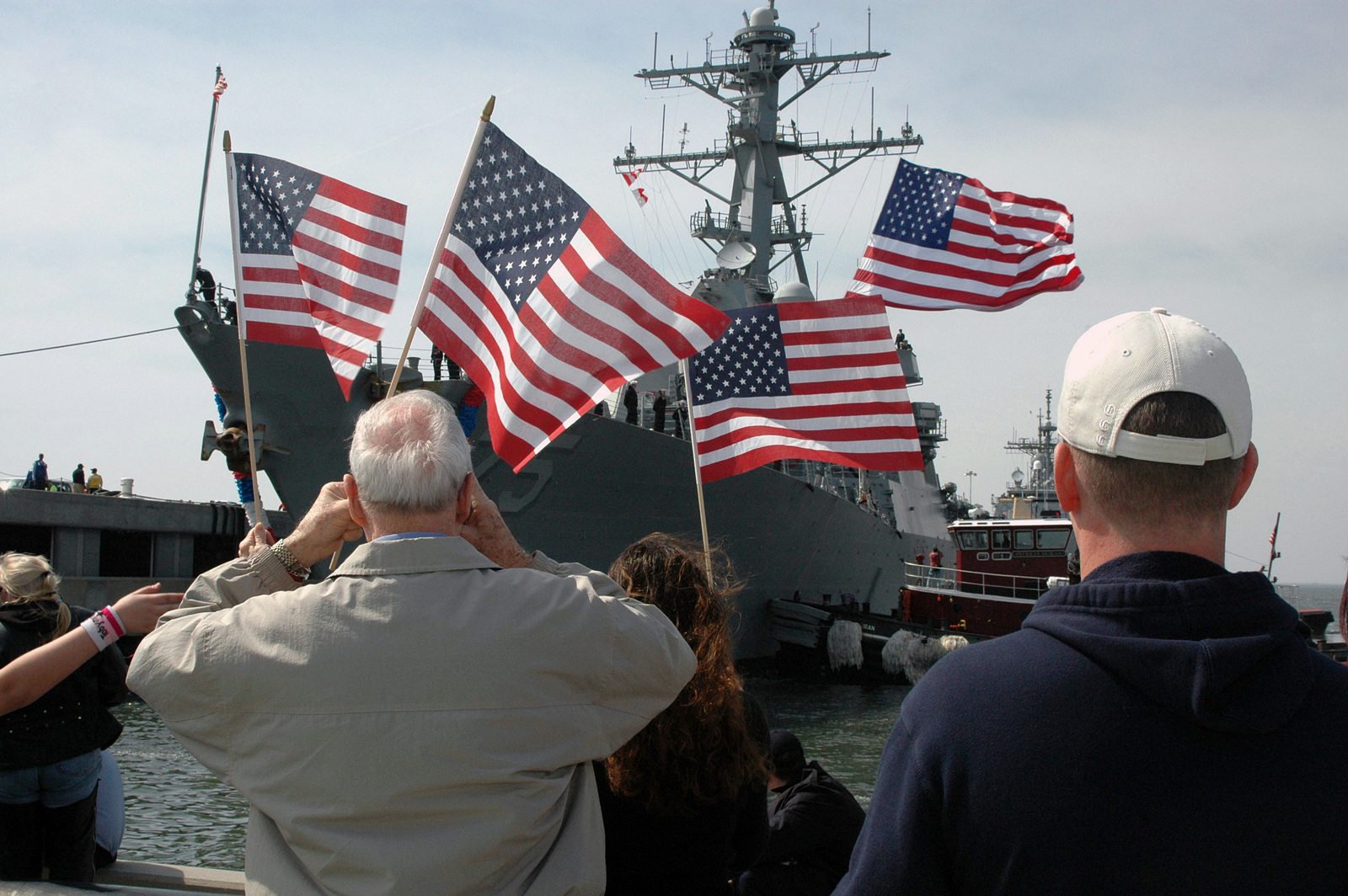 At Norfolk Virginia Va Family Members Wave American Flags As They Anxiously Wait For Their Loved