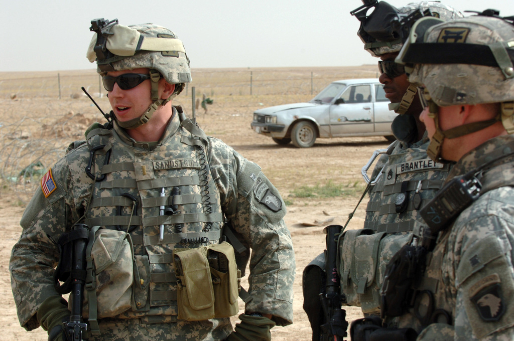 U.S. Army STAFF SGT. William McCabe and James Brantley talk with