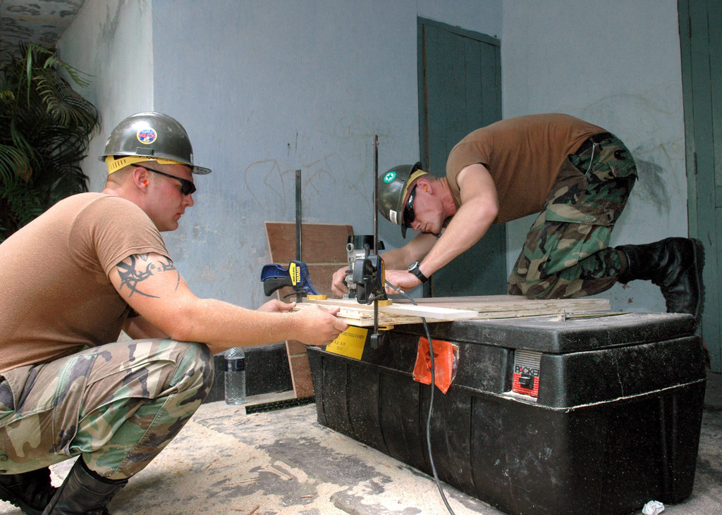 US Navy (USN) Navy Builder Third Class (BU3) Adam Kortmeyer (right) And ...