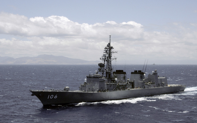 Capt. David Schappert, left, commander of Submarine Squadron 15, observes  the Japan Maritime Self-Defense Force submarine JS Soryu (SS-501) as it  arrives in Apra Harbor, Guam, for a port visit. - PICRYL 