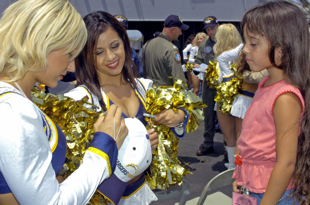 This Dallas Cowboys Cheerleader, Angela (the team does not publicize the  last names of its cheerleading squad members), and about 35 others,  entertain the crowd at a National Football League game at