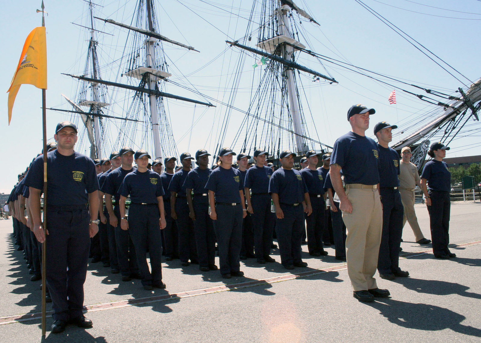 U.S. Navy CHIEF PETTY Officer selectees stand in ranks in front of the