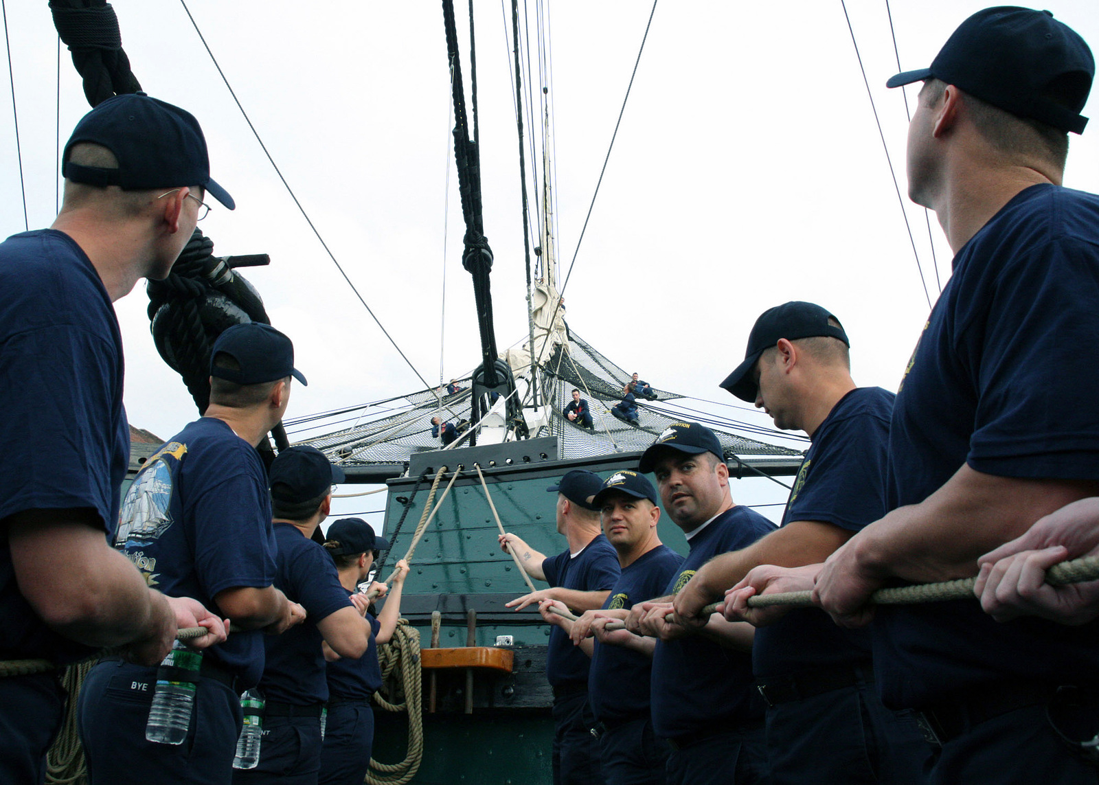 U.S. Navy CHIEF PETTY Officer selectees heave lines to set the jib