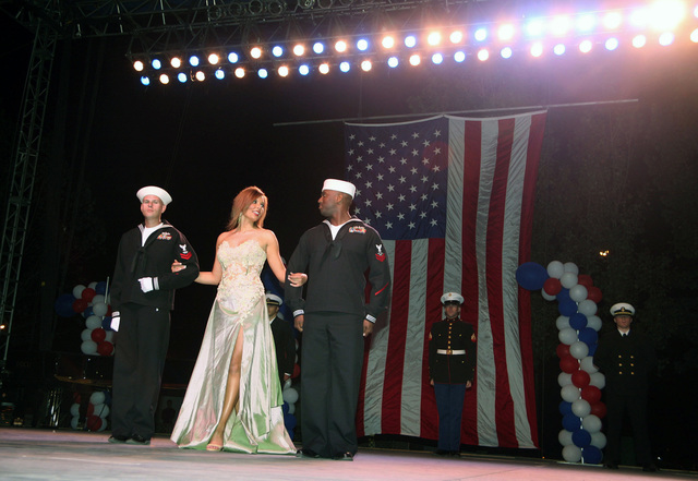 Area Sailors take part in the Miss Utah State Fair Competition by escorting the ladies during ...