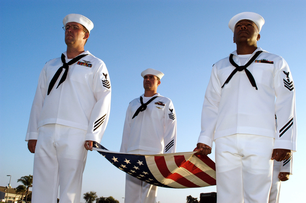 A U.S. Navy Color team presents the American flag during a flag ...