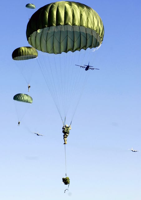 Soldiers of the 173rd Airborne Brigade Combat Team exit a C-130 ...