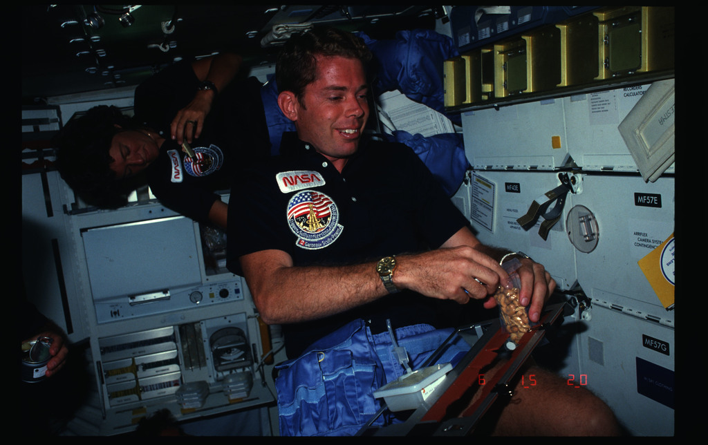 41G-02-033 - STS-41G - Leestma and Ride eating in the FWD MDDK during ...