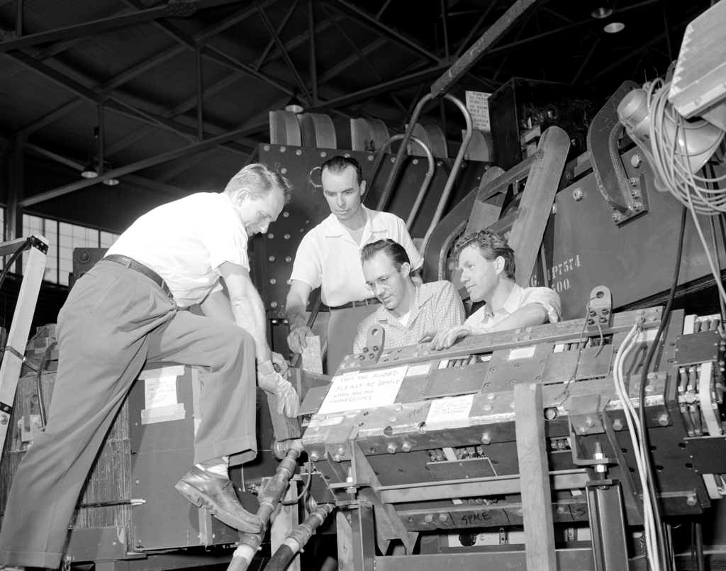 Anti-neutron discovery team with the focus magnet of the bevatron  accelerator, the machine they used to create and detect the anti-particle  of the neutron. From left: William Wenzel, Bruce Cork, Glen Lambertson