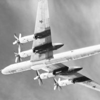 A left underside view of a Soviet Tu-95 Bear D aircraft in flight