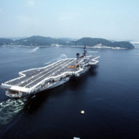 With its crew manning the rails, the aircraft carrier USS MIDWAY