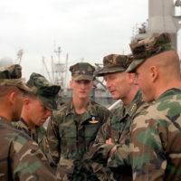 GEN. Walter E. Boomer, assistant commandant of the Marine Corps, converses  with a Marine officer aboard the amphibious transport dock USS TRENTON  (LPD-14) following his arrival on base to observe a special