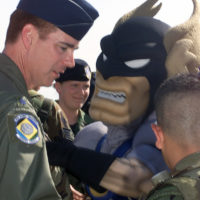 Illinois Army National Guard 2nd Lt. Zachary White, of Chicago, takes a  photo with Staley Da Bear, the Chicago Bears mascot during the Chicago Bears  Salute to Service game Nov. 27 at