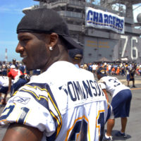 Offensive Tackle for the National Football League (NFL) San Diego Chargers,  Leander Jordan (75), signs an autograph for Aviation Electrician's Mate 3rd  Class Jerimy Holt during a visit aboard USS Ronald Reagan (